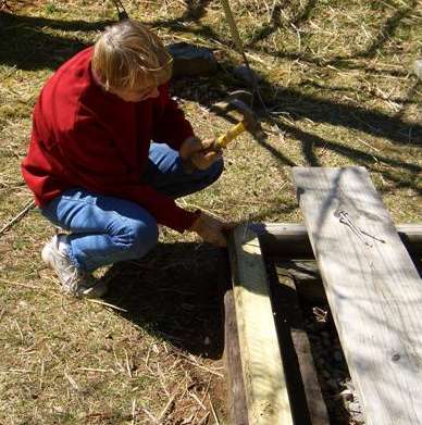 Master carpenter demonstrating use of her hammer