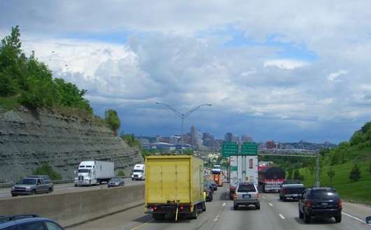 Heavy traffic, down a steep grade, into a major city and a heavy rainstorm ahead