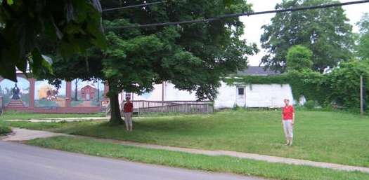 Linda showing where the front two corners of the store once stood.